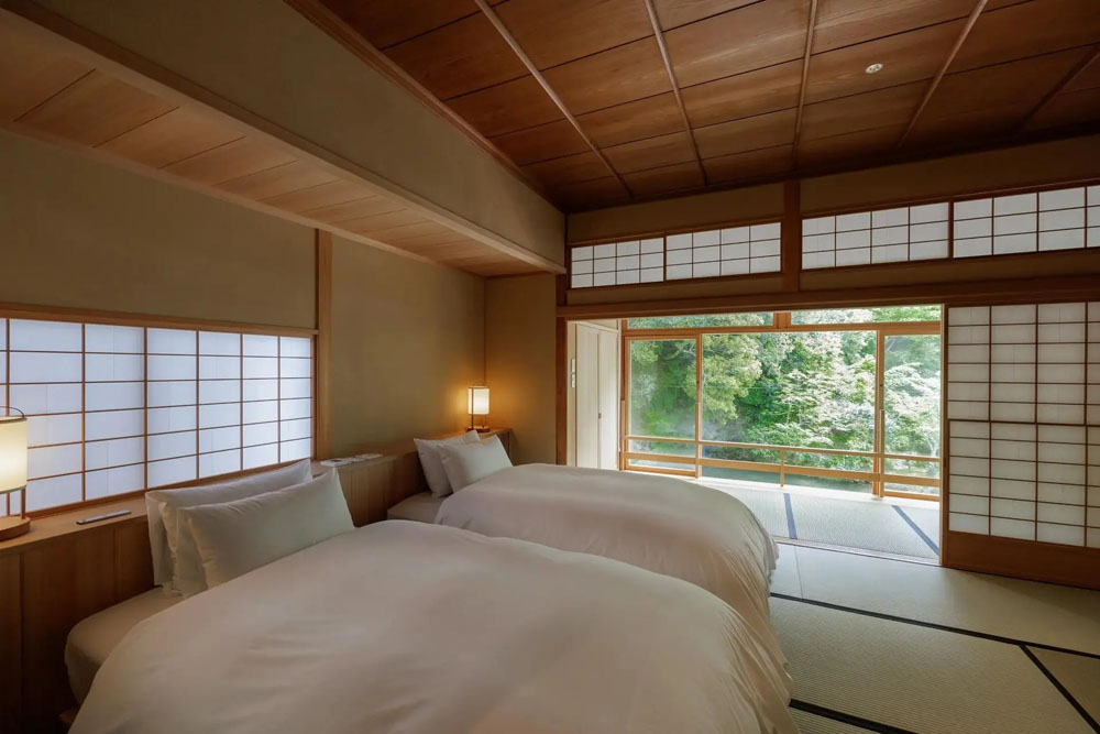 Secondary guest room at Asaba — distinct layout from primary bedroom, PressBeyond hotel image sequence