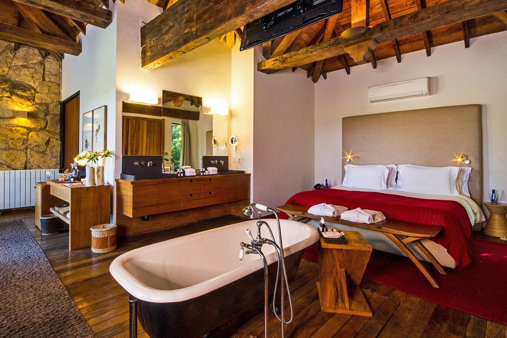 Secondary guest room at Botanique Hotel Experience — distinct layout from primary bedroom, PressBeyond hotel image sequence