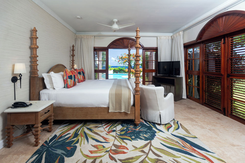 Primary guest room at Cap Maison Resort & Spa — full-room view, natural lighting, clear sightlines, PressBeyond standard