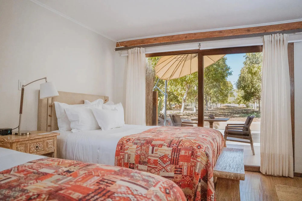 Primary guest room at CasaMolle — full-room view, natural lighting, clear sightlines, PressBeyond standard