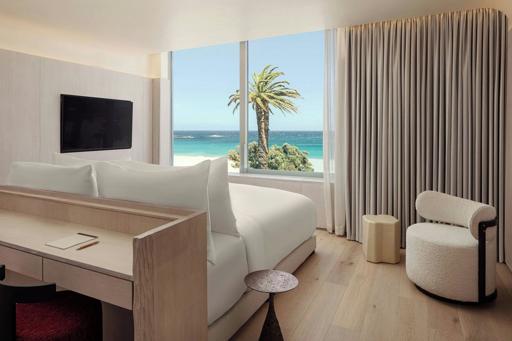 Primary guest room at Morea House, Autograph Collection — full-room view, natural lighting, clear sightlines, PressBeyond standard