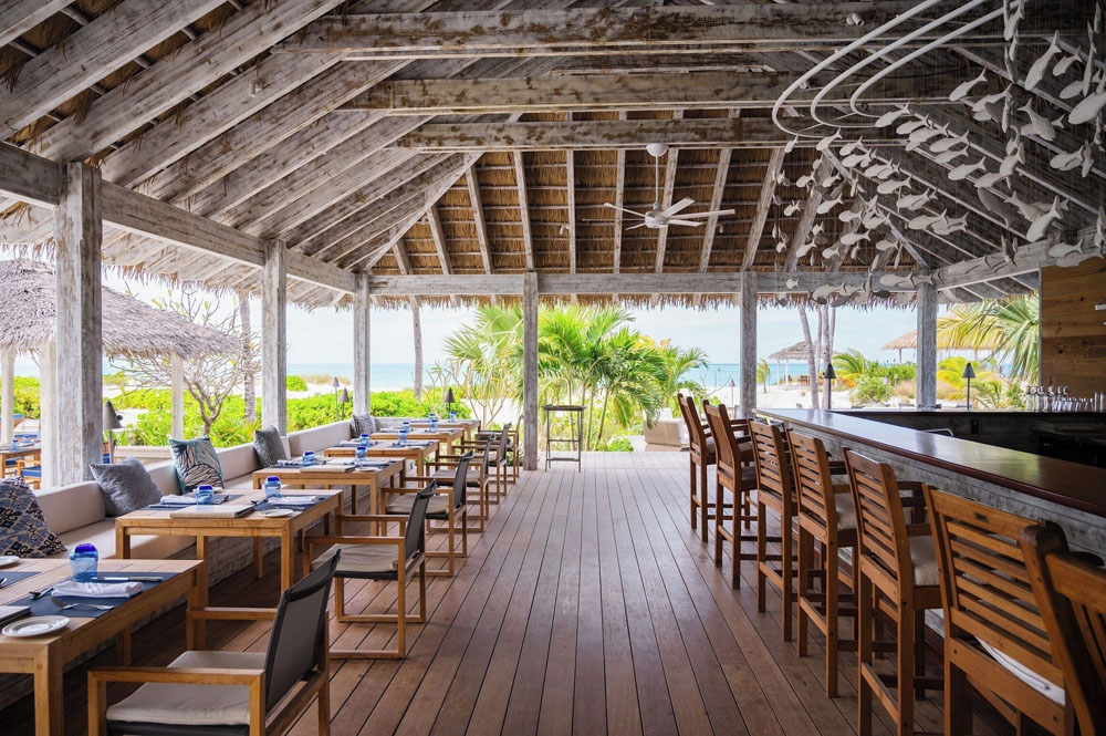 Common area at Pine Cay — lobby or lounge, non-duplicative with secondary social space, PressBeyond