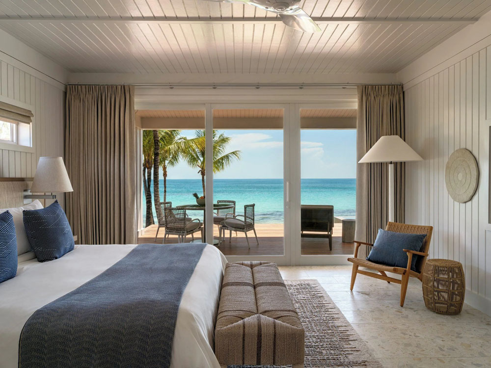 Primary guest room at The Cove Eleuthera — full-room view, natural lighting, clear sightlines, PressBeyond standard