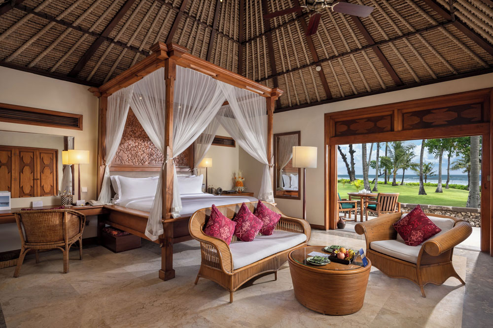Primary guest room at The Oberoi Beach Resort, Bali — full-room view, natural lighting, clear sightlines, PressBeyond standard