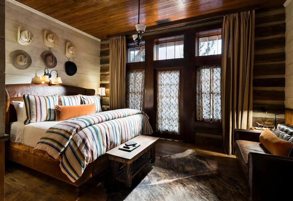 Primary guest room at The Ranch at Rock Creek — full-room view, natural lighting, clear sightlines, PressBeyond standard