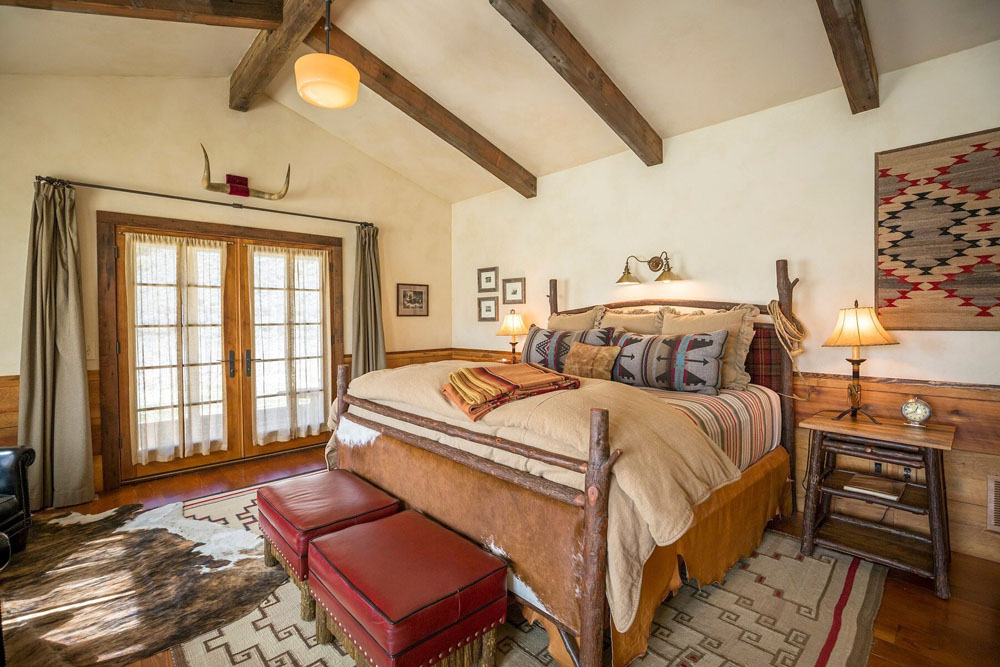 Secondary guest room at The Ranch at Rock Creek — distinct layout from primary bedroom, PressBeyond hotel image sequence